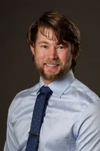 Dr. Allen Johnson wearing a button up and tie.
